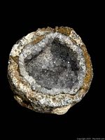 Top view of clear crystal geode showing sparkling quartz crystals inside the hollow cavity
