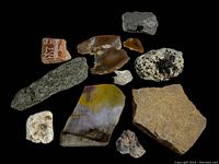 Top view of 10 assorted stones and crystals on a black background showing various textures and colors for identification.
