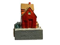 Front view of the motif sculpture showing the red building on the dock with chimney and side barrel.