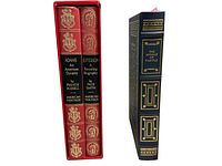 Side view of three vintage books, two in a red slipcase with gold detailing, one dark blue with gold embossing.