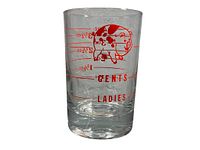Side view of clear vintage glass measuring cup with red pig graphic and measurement markings, showing 'Gents' and 'Ladies' labels and measurement lines to 3.5 oz.