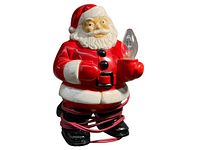 Front view of vintage plastic Santa lamp holding a clear light bulb, with red cord wrapped around base.