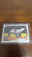 George Springer rookie baseball card showing Springer sliding on the field, protected in plastic sleeve.