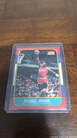 Front view of Michael Jordan 1986 Fleer basketball rookie reprint card showing action photo and card details.