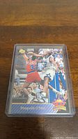 Photo of Shaquille O'Neal rookie basketball card in a plastic protective sleeve with the player in action on the front showing Upper Deck Top Prospects logo and name.