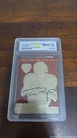 Front of 2000 Merrick Mint Feel The Game Tom Brady rookie card showing graded label WCG 10 Gem Mint and card image with gold foil and facsimile autograph.