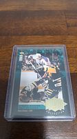 Front view of Wayne Gretzky hockey card featuring game action photo and gold foil lettering with limited edition serial number 2/15.