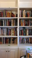 12 shelves of books including titles on history, internet technology, religion, and cookbooks