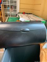 Closed black Cricut craft cutting machine with visible logo