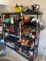 Front view of two black plastic shelving units filled with various household and decorative items.