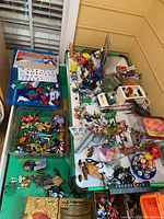 Overview of assorted figurines and toys on air hockey table