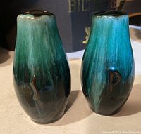 Front view of blue-green gradient salt and pepper shakers showing the embossed letters 'S' and 'P'.