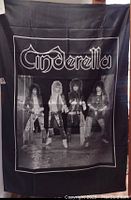 Photo of the black nylon Cinderella banner featuring the band logo and a black and white band photo