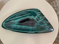 Top view of large ceramic ashtray with triangular shape and teal-black glaze