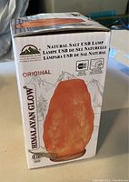 Box packaging for Himalayan Glow Natural Salt USB Lamp, showing product image and branding details.