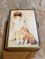 Top view of curio box lid showing illustration of child and dog