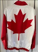 Back of jacket showing large red maple leaf on white background with red sleeves.