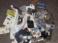 Overview of assorted new jewelry items in plastic bags and on cards