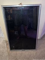 Front view of the display case showing the locked glass front and metal frame