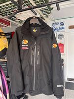 Black Bass Pro Shops GORE-TEX waterproof jacket showing front with multiple zippered pockets, size large tall.