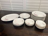 Full set of Golden Rose fine china arranged on table showing all items: serving plate, serving bowl, dinner plates, bowls, bread plates, and finger bowls