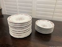Stack of 16 plates and 8 bowls showing floral pattern and size