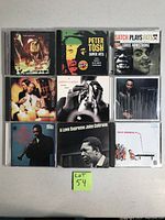 Photo shows nine CD cases arranged in a grid with jazz and reggae artists including Peter Tosh, Bob Marley, John Coltrane, James Carter.