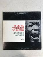 Front cover of John Lee Hooker 'It Serve You Right To Suffer' 12" vinyl album showing artist photo and album title.