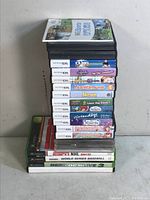 Stack of Nintendo DS and Xbox video games in cases