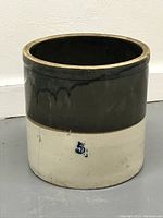 Full view of vintage 5-gallon two-tone glazed stoneware crock, showing dark upper and cream lower section with blue number '5'.