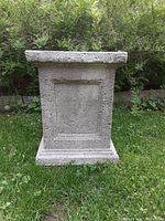 Front view of fibreglass garden pedestal showing textured surface and recessed panel on front face