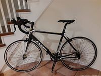 Full view of Jamis Ventura Comp road bike, black with yellow accents