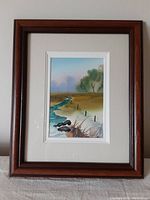 Framed watercolor painting of a pastoral scene showing the overall framed artwork including the triple mats and wooden frame.
