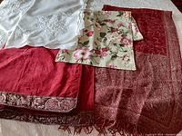 All four textiles shown layered to display variety in color, texture and size.