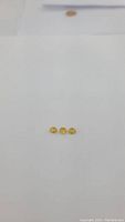 Three oval-cut natural canary yellow sapphires displayed on a white background showing strong yellow color and clarity.