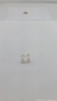 Front view of small square rainbow moonstone stud earrings with 925 sterling silver setting and posts.