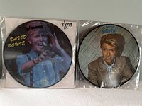 Two David Bowie picture disc albums sealed in plastic, showing distinct album artwork.