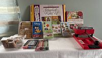Wide shot of scrapbooking materials including craft books, cartridges, stamps, pens, and the Sizzix die cutter.