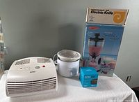Overview showing all items: Holmes air purifier, small Crockpot slow cooker, electric smoothie maker box, Echo Dot box, Rowenta steambrush box