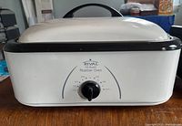 White Rival 16-quart roaster oven with temperature control knob on front.