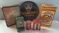 Group photo showing all five vintage tins and one vintage serving tray on a flat surface