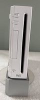Nintendo Wii console front view showing power button, reset button, disc slot, and eject button.