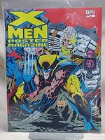 Front cover of the X-Men Poster Magazine showing Wolverine and other characters in vibrant comic artwork, bagged and boarded for protection.