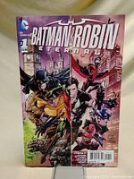 Front cover of Batman & Robin Eternal #1 comic book showing main characters and city background