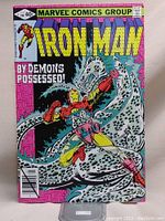 Front cover of Iron Man comic book issue #130 featuring Iron Man battling a large white demonic figure with black spots labeled 'By Demons Possessed!'