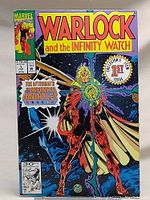 Full front cover of Warlock and the Infinity Watch #1 comic, featuring main character and colorful background, showing bagged and boarded condition.