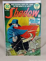 Front cover of The Shadow #2 comic showing the main character aiming a gun with clear branding and price.