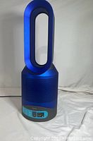 Full front view of blue and gray bladeless fan heater purifier on white background