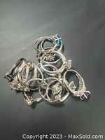 Top view of the collection of 15 sterling silver rings showing the silver bands and varied gemstone colors.