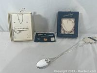 Photo showing the full set of jewelry items: boxed A New Day 5-piece set, Napier necklace in box, Universal Thread bracelet and rings, and a long silver-tone chain necklace with a large pendant.